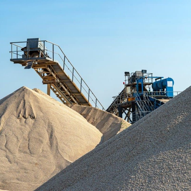 conveyor-belt-over-heaps-of-gravel-against-the-blu-2023-11-27-05-23-19-utc-qvaluiioy2h2t3cg1fg63bj1fzsdn1bzbashpysq4g